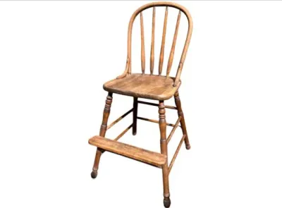 Sale Photo Thumbnail #24: Vintage wooden youth chair with a spindle back and footrest, featuring a weathered finish.