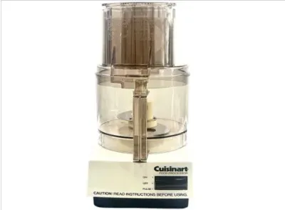 Sale Photo Thumbnail #122: Vintage white Cuisinart electric food processor featuring a clear work bowl, lid with feed tube, and multi-function lever control.