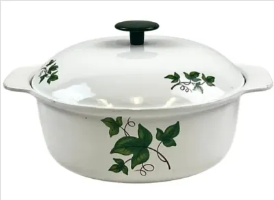 Sale Photo Thumbnail #115: Vintage white enamel Dutch oven featuring a green ivy pattern and dark green lid knob.