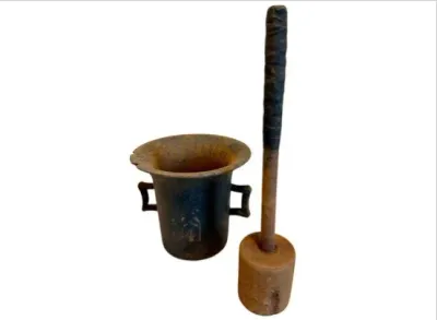 Sale Photo Thumbnail #82: Antique cast iron mortar with double side handles, accompanied by a long-handled wooden pestle with a wrapped grip.