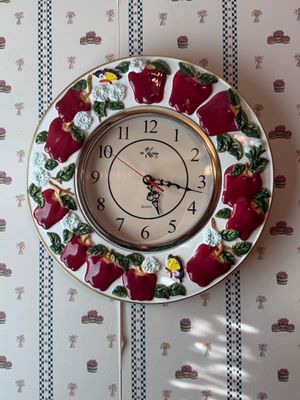 Sale Photo Thumbnail #26: Vintage ceramic wall clock featuring relief-sculpted red apples, white blossoms, and butterflies along the rim.