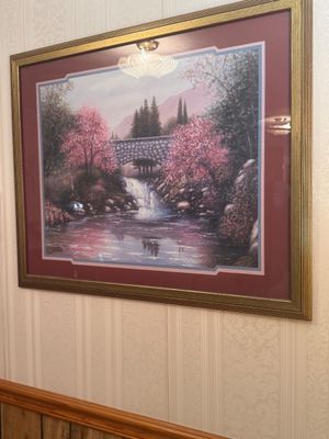 Sale Photo Thumbnail #19: Framed landscape art print featuring a stone bridge, waterfall, and cherry blossom trees, housed in a gold-finished frame with maroon matting.
