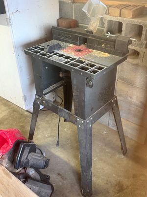 Sale Photo Thumbnail #9: Craftsman router table with a metal stand, fence, and safety guard, showing signs of light workshop use.