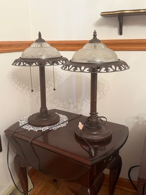Sale Photo Thumbnail #16: Pair of traditional bronze-toned table lamps featuring fluted columns, frosted floral glass shades, and filigree metal rims.