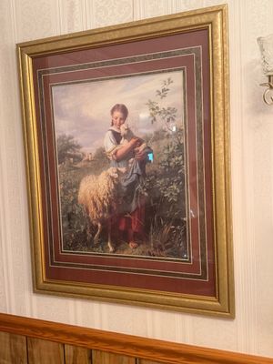 Sale Photo Thumbnail #20: Framed pastoral art print depicting a shepherdess holding a lamb alongside a sheep, presented in a ornate gold-finished frame with multi-layered matting.