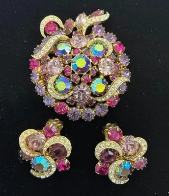 Sale Photo Thumbnail #64: Vintage gold-tone rhinestone brooch and matching clip-on earrings set, featuring pink, purple, and aurora borealis crystal accents.