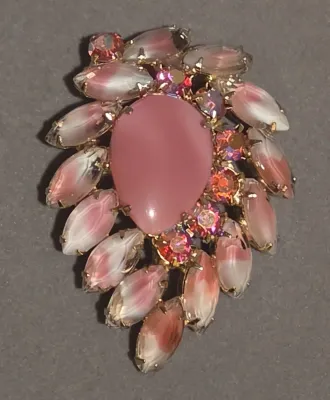Sale Photo Thumbnail #42: Vintage mid-century pink costume jewelry brooch featuring a central teardrop cabochon surrounded by marquis-cut swirled glass stones and aurora borealis rhinestones.