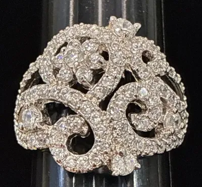 Sale Photo Thumbnail #98: Intricate white gold or platinum cocktail ring featuring a pavé diamond scroll and floral cluster design.