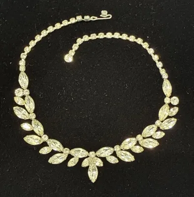 Sale Photo Thumbnail #54: Vintage rhinestone necklace featuring a leaf-motif garland set with marquise and round cut stones, circa mid-20th century.