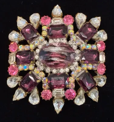 Sale Photo Thumbnail #89: Vintage statement brooch featuring purple, pink, clear, and aurora borealis rhinestones in a prong setting, mid-20th century.