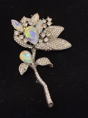 Sale Photo Thumbnail #60: Vintage floral brooch featuring clear rhinestones and iridescent aurora borealis pear-cut crystal accents set in a silver-tone metal frame.