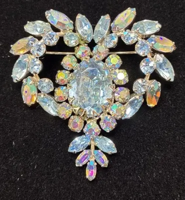 Sale Photo Thumbnail #101: Vintage iridescent aurora borealis rhinestones brooch featuring a central oval stone framed by marquise and chaton cuts.