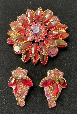 Sale Photo Thumbnail #78: Vintage red and pink rhinestone floral brooch and matching clip-on earrings set in pronged gold-tone metal settings.