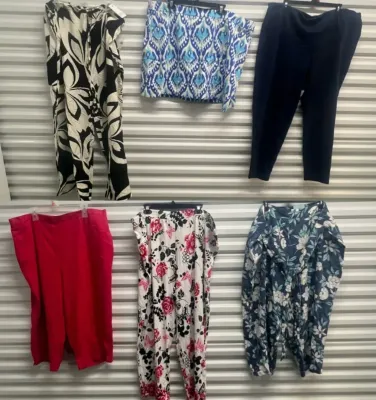 Sale Photo Thumbnail #51: Collection of women's pants and shorts featuring floral, geometric, and solid patterns hanging on display.