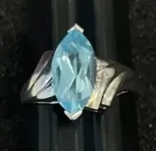 Sale Photo Thumbnail #18: Marquise-cut light blue topaz ring set in a textured silver-tone band.
