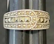 Sale Photo Thumbnail #19: Vintage sterling silver and marcasite buckle-motif ring with textured milgrain borders and pyramid-cut center stones.