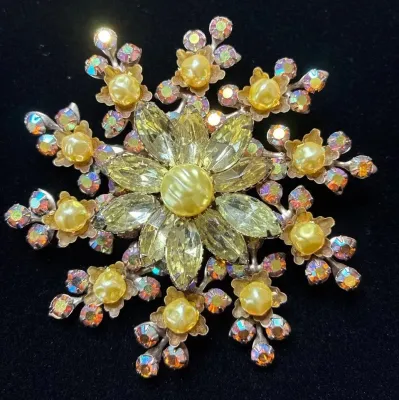 Sale Photo Thumbnail #55: Vintage starburst floral brooch featuring yellow marquise rhinestones, faux pearl centers, and iridescence aurora borealis accents.