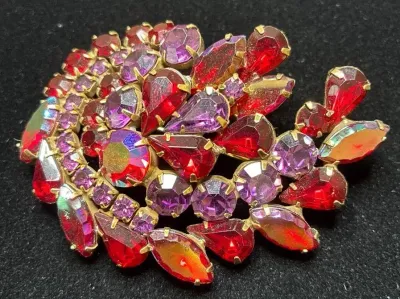 Sale Photo Thumbnail #92: Vintage gold-tone brooch set with tiered red, purple, and aurora borealis rhinestone crystals in teardrop and round cuts.