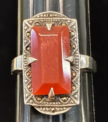 Sale Photo Thumbnail #114: Vintage Art Deco style sterling silver ring featuring a rectangular emerald-cut carnelian stone framed by marcasite accents.