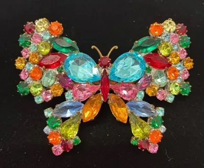 Sale Photo Thumbnail #70: Vintage multi-color rhinestone butterfly brooch featuring various shapes and shades of prong-set glass stones.