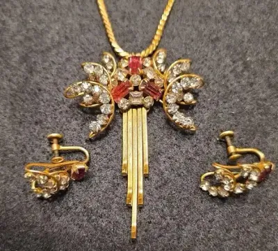Sale Photo Thumbnail #3: Vintage gold-tone rhinestone jewelry set featuring a statement pendant necklace with pink and clear crystals and matching screw-back earrings.