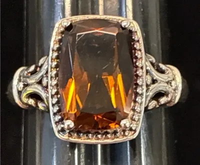 Sale Photo Thumbnail #93: Sterling silver statement ring featuring a cushion-cut smoky quartz gemstone with a beaded halo and filigree shoulders.
