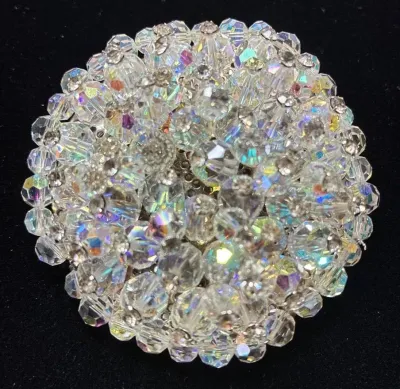 Sale Photo Thumbnail #68: Vintage aurora borealis crystal bead cluster brooch featuring multi-faceted iridescent glass beads arranged in a domed circular design.