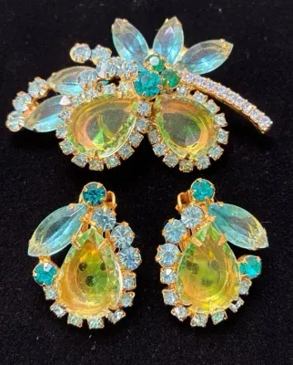 Sale Photo Thumbnail #109: Vintage gold-tone rhinestone brooch and clip-on earrings set featuring iridescent yellow pear-shaped stones and teal accents.