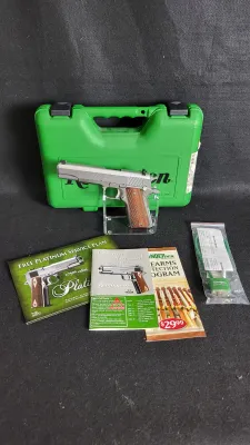 Remington 1911 R1 stainless steel semi-automatic pistol with wood grips, displayed with green hard case, owner's manual, paperwork,...