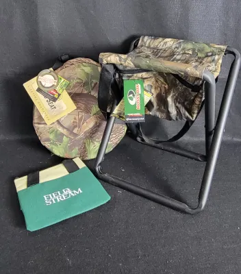 Mossy Oak folding camo hunting stool with under-seat storage pouch alongside a round camo seat cushion and a green Field & Stream...