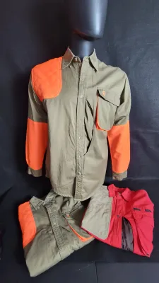 Browning brand long-sleeve hunting shirt in olive green and safety orange displayed on a mannequin, alongside two folded hunting shirts...
