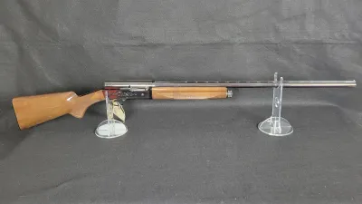 Browning Auto-5 semi-automatic shotgun with an engraved receiver, checkered wooden stock and forend, and a ventilated rib barrel.
