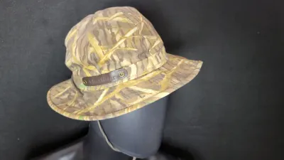 McAlister camouflage hunting bucket hat featuring a leather logo patch and chin strap.