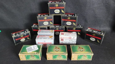 Collection of assorted 12-gauge shotgun ammunition boxes, including Winchester Supreme, Winchester Super X, and Hevi-Shot turkey loads.
