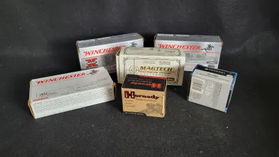 Collection of six modern ammunition boxes, including Winchester, Magtech, Hornady, and Federal brands in various calibers.