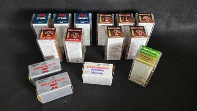 Collection of .22 Win Mag ammunition boxes, including brands like Hornady, CCI, Winchester, and Remington.