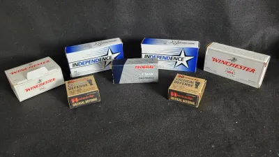 Assortment of handgun ammunition boxes, including Winchester, Independence, Hornady Critical Defense, and Federal Classic.