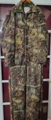 Vintage Walls camouflage insulated hunting coveralls featuring a woodland leaf print and full front zipper.