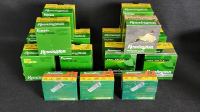 Large collection of Remington shotgun shell ammunition boxes, including Express Long Range, Nitro Magnum, and Pheasant Loads varieties.