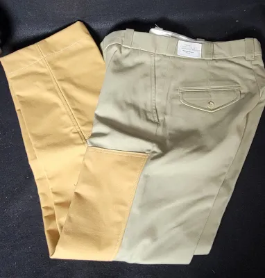 Vintage tan hunting trousers with reinforced yellow canvas leg panels and a rear flap pocket, appearing in unworn condition with original...