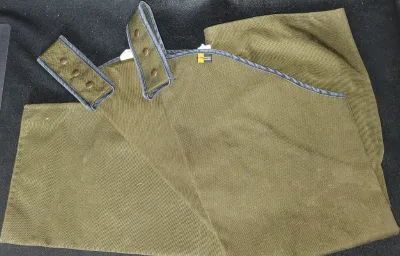 Pair of olive green Cordura canvas hunting chaps with adjustable snap belt loops.