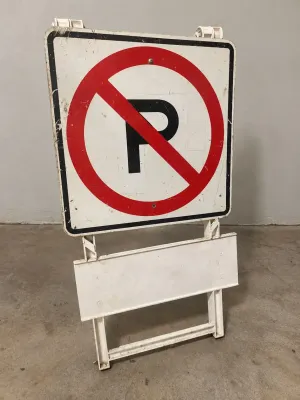 NO PARKING STREET SIGN AND PLASTIC BARRIER