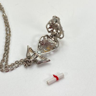 LOT 529: Large Collection of Silver Tone Jewelry - Earrings, Necklaces (Locket with Paper Scroll) and Fashion Watches