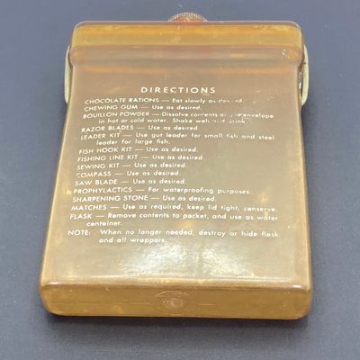 LOT 524: Vintage Military Collection - Survival Kit Plastic Rations Flask, Canteen, Pewter Eagle Figurine and More