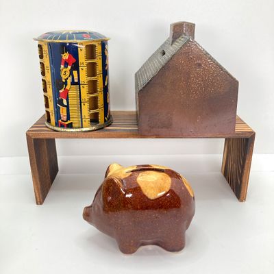 LOT 531: Vintage Coin Bank Collection - Tin Litho Rotary Sorter, Ceramic Cabin, Tin Litho Rotary Sorter, Rexair Vacuum and Piggy Bank