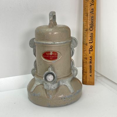 LOT 531: Vintage Coin Bank Collection - Tin Litho Rotary Sorter, Ceramic Cabin, Tin Litho Rotary Sorter, Rexair Vacuum and Piggy Bank