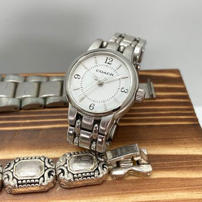 LOT 529: Large Collection of Silver Tone Jewelry - Earrings, Necklaces (Locket with Paper Scroll) and Fashion Watches