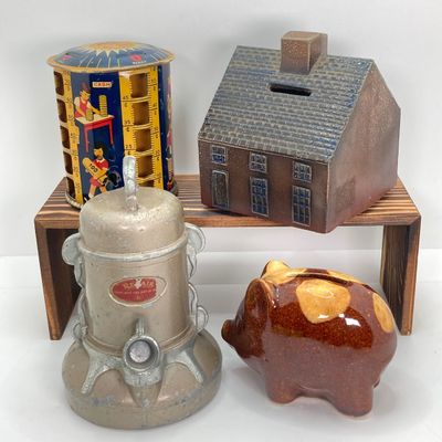 LOT 531: Vintage Coin Bank Collection - Tin Litho Rotary Sorter, Ceramic Cabin, Tin Litho Rotary Sorter, Rexair Vacuum and Piggy Bank
