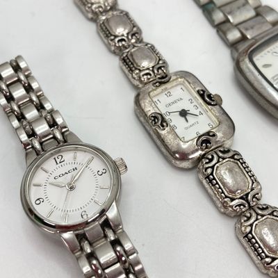 LOT 529: Large Collection of Silver Tone Jewelry - Earrings, Necklaces (Locket with Paper Scroll) and Fashion Watches