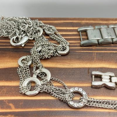 LOT 529: Large Collection of Silver Tone Jewelry - Earrings, Necklaces (Locket with Paper Scroll) and Fashion Watches